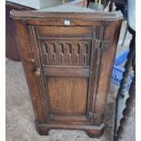 A distressed oak small corner cupboard, floor standing, in the style of Waring & Gillow (no top
