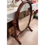 A large mahogany framed, Victorian, oval  dressing table mirror.