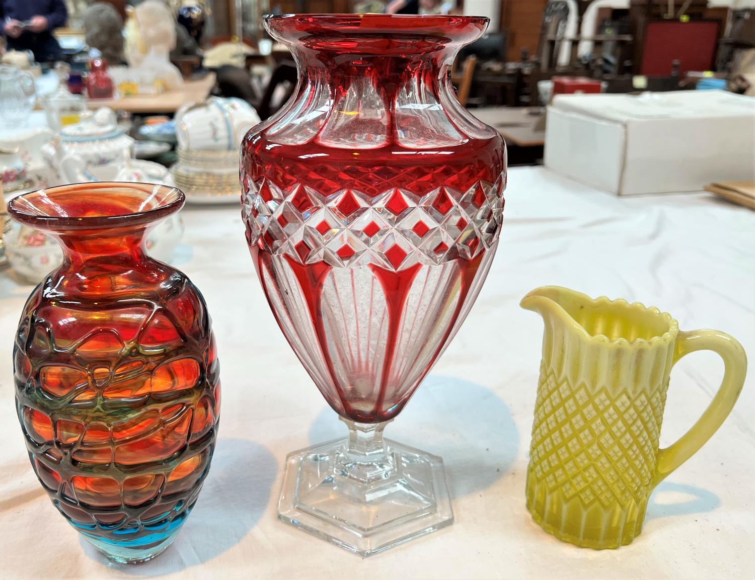 A ruby overlaid glass vase; a Mdina vase; a vaseline glass jug; a Coalport Indian Tree vase