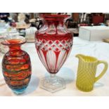 A ruby overlaid glass vase; a Mdina vase; a vaseline glass jug; a Coalport Indian Tree vase