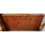 A 20th century teak G-Plan sideboard with three cupboards and single drawer, length 132cm