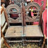 A 17th century style pair of oak Lancashire chairs, with carved backs and figural columns ( some