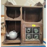 A small wall cabinet with leaded glass door; a corner shelf unit; an oval wall mirror in gilt frame