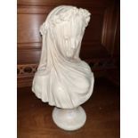 A plaster bust:  head and shoulders of a veiled bride