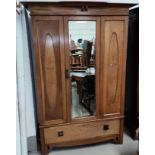 A late 19th/early 20th Arts & Crafts inlaid wardrobe with mirror door