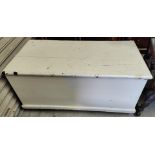 A white painted pine chest with hinged lid
