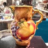 A Royal Worcester hand painted miniature mask jug, exclusive for Bennett's, Derby, with gold back