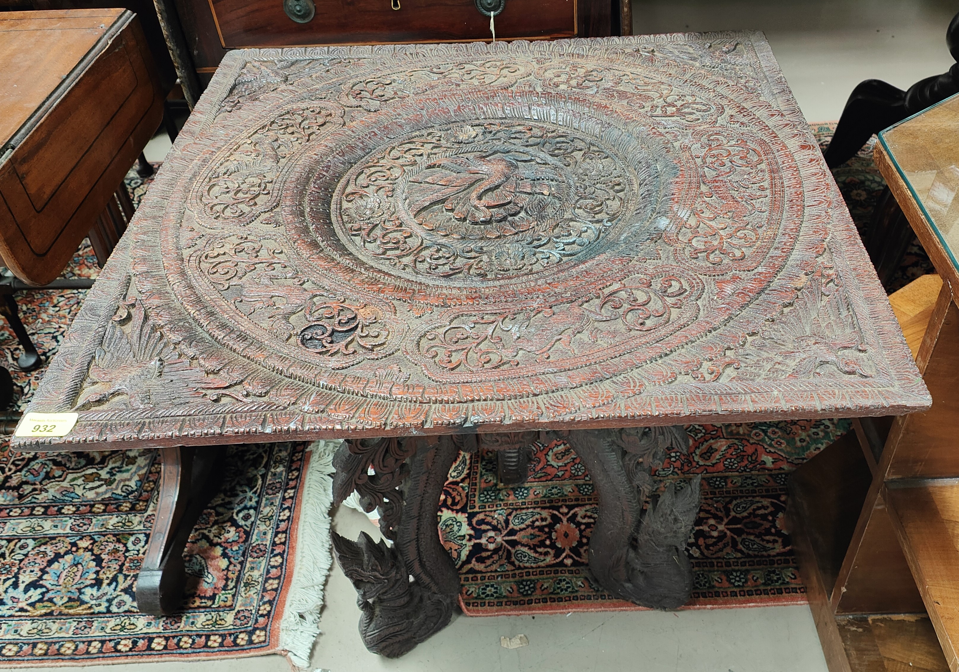 An oriental occasional table with extensively carved square top
