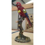 A leaded glass parrot lamp on composition base, 44cm