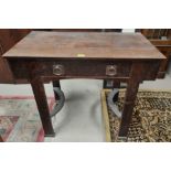 A late 19th/early 20th century Arts & Crafts oak side table with heavy brass ring handles to the