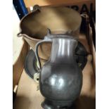 A large 18th century pewter charger; a large 18th century pewter flagon and a brass gong, jam pan