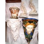 A majolica female face wall bracket; a wall pocket by Charlotte Rhead; a plaster female head wall