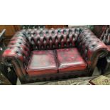 A Chesterfield 2 seater settee in buttoned oxblood hide