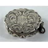 A hallmarked silver oval chased vinaigrette, monogrammed, Birmingham 1861, possibly Huskin & Heath