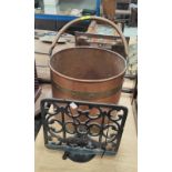 A copper coal bucket; a cast iron book stand; a pair of brass candlesticks and a brass letter rack