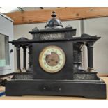 A 19th century mantel clock in architectural black marble case with domed top and Corinthian side