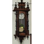 A mahogany Vienna Wall Clock with turned columns and finials.