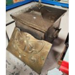 An Art Nouveau embossed brass coal bin; a similar fire cowl