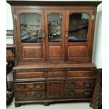 A mid 18th century oak country made dresser/press cupboard with moulded and dentil cornice, the