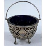 A hallmarked silver sugar bowl, pierced and chased, with heavy blue glass liner, Birmingham 1861,