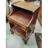 An Edwardian oak 2 tier bedside cabinet with square top; a stained wood bedside cabinet