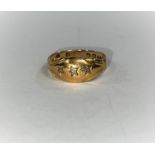 An 18 carat hallmarked gold gypsy style ring set 3 small diamonds, 2.6 gm, size 'M'