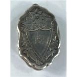 A silver oval vinaigrette with chased decoration and monogrammed cartouche, Birmingham 1880, by