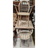 A 1960's Ercol light elm dining suite comprising square table and a pair of carver chairs (in need