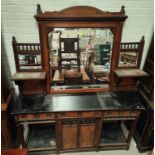 An Aesthetic Movement walnut sideboard, the upper section with mirrors, side shelves and spindle