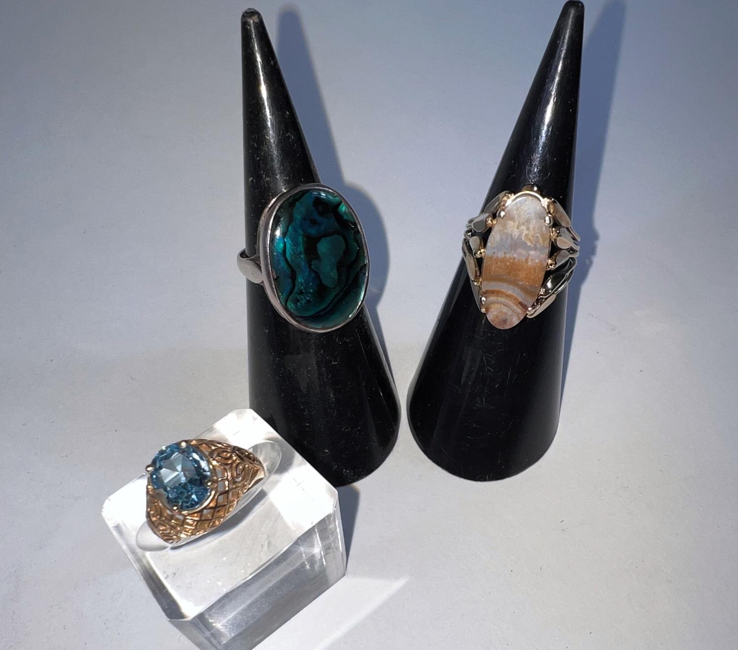 A hallmarked silver lady's dress ring set with oval abalone shell; 2 yellow metal rings, 1 set