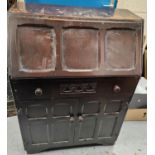 An oak Jacobean style bureau with drawers bellow fall front