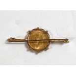 A yellow metal bar brooch stamped 9ct set with George V half sovereign, 6.8gm