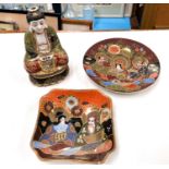 A 20th century satsuma figure of a buddha in the lotus position; a similar plate and square dish (