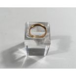 A barrel shaped yellow metal wedding ring, tests as  gm, 5.1gm