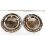 A Georgian hallmarked silver pair of platters with gadroon and leaf wavy rims, crested, London 1761,