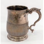 A hallmarked silver baluster half pint mug with reeded lower body, on circular foot, inscribed to