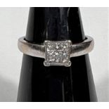 A white metal ring, stamped '750', with 9 square diamonds in square setting