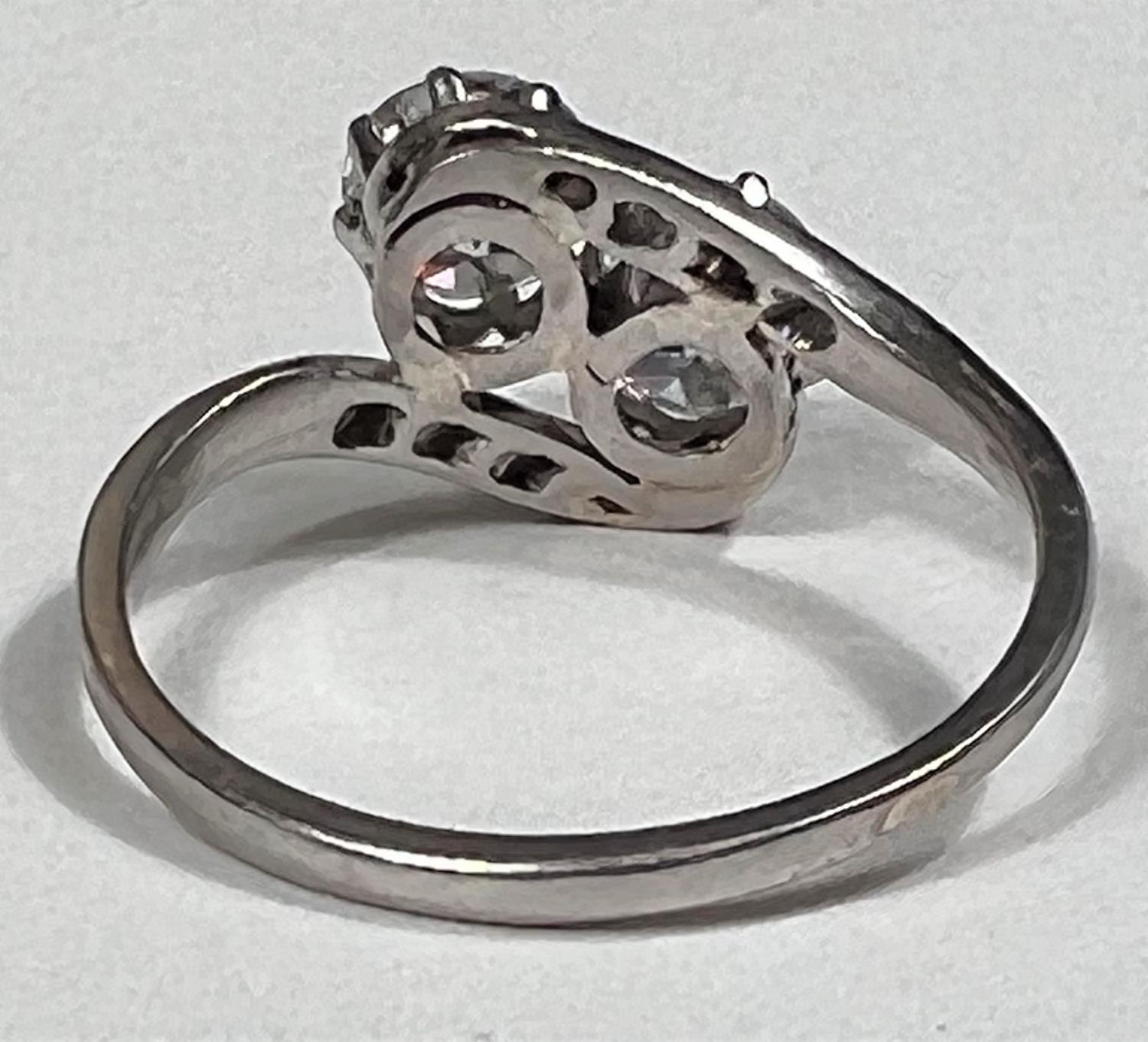 A white metal ring stamped 'Pt', with 2 diamonds in crossover setting, each shoulder set 4 small - Image 4 of 7