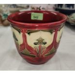 A Minton 'Secessionist' plant pot holder decorated with stylised flowers against a red ground,
