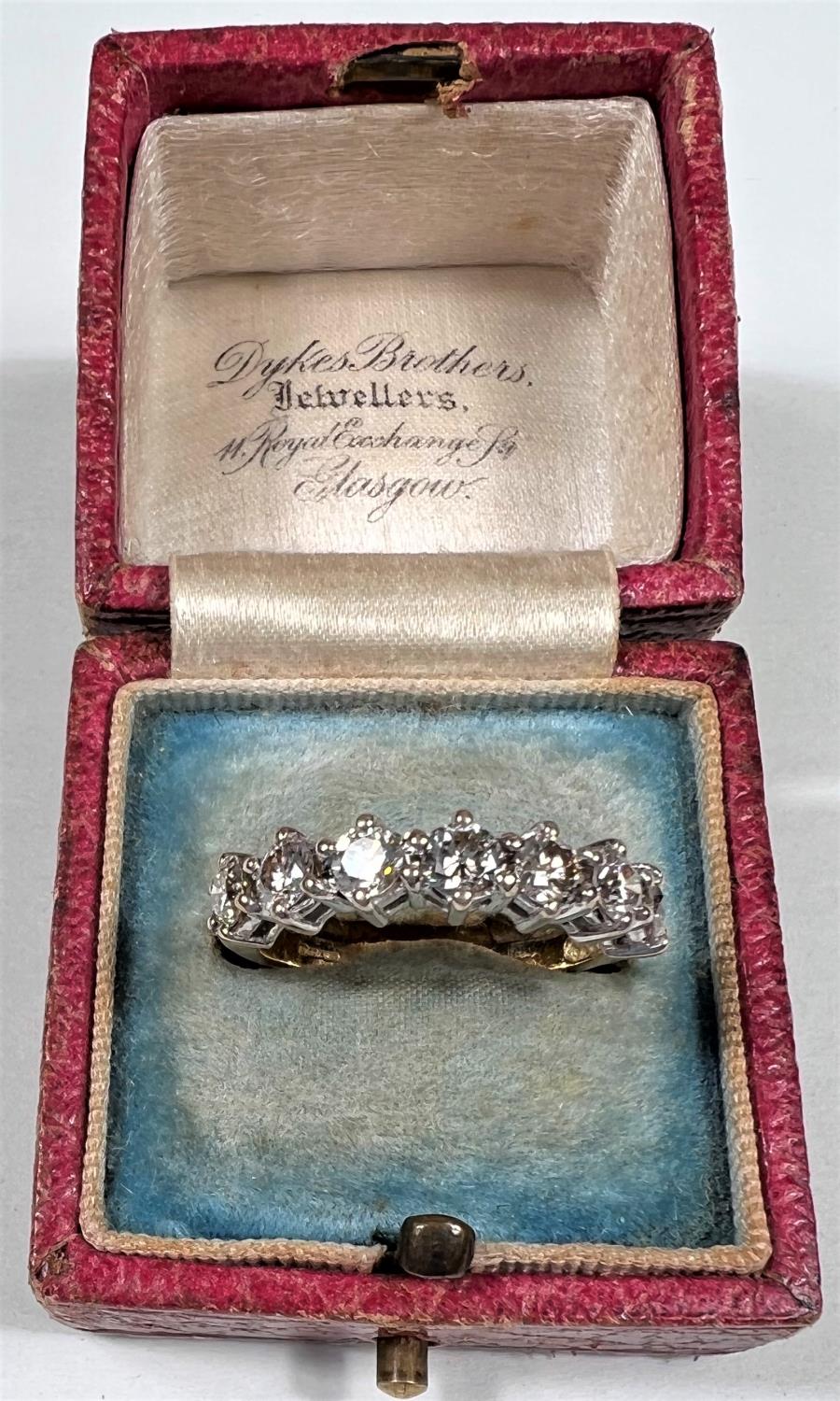 An 18 carat hallmarked gold half eternity ring set 7 diamonds, 3.5mm diameter of stones approx