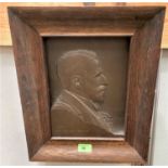 A relief bronze plaque in oak frame, side view head and shoulders of Sir Evan Spicer, 27.5 x 20cm