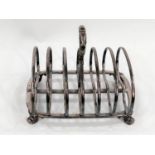 A hallmarked silver 6 division toast rack with kidney shaped dividers with central ring handle, on 4