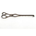 An 18th century hallmarked silver pair of asparagus tongs, scissor shaped, the edges with incised