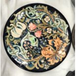 A Moorcroft large circular shallow dish decorated with stylised leaves and flowers in the style of