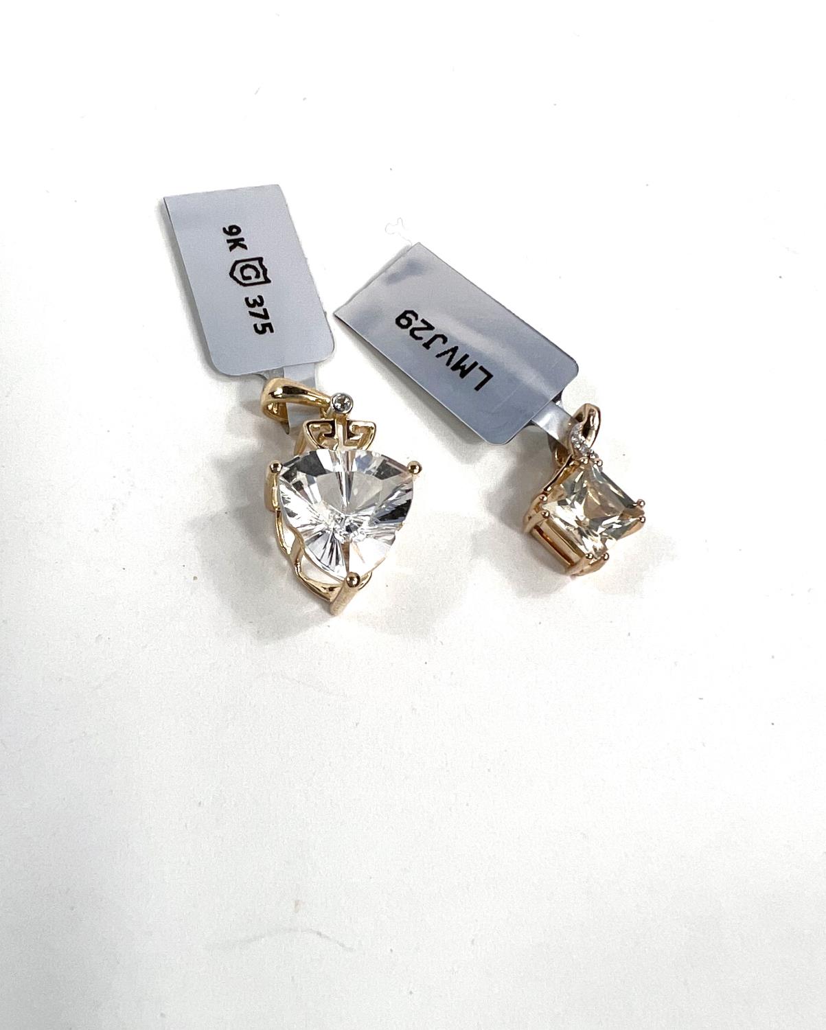 Two 9ct hallmarked gold pendants, 1 set with triangular optic quartz and sky blue Topaz, the other