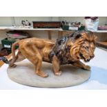 A fine ceramic male lion on marble base