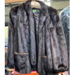 A dark brown 3/4 length mink coat; a mink and leather jacket