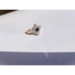 A 9ct hallmarked gold diamond dress ring in the form of a cross with central blue diamond 0.49