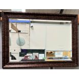 A bevelled edge wall mirror in rectangular 'antique' effect gold frame