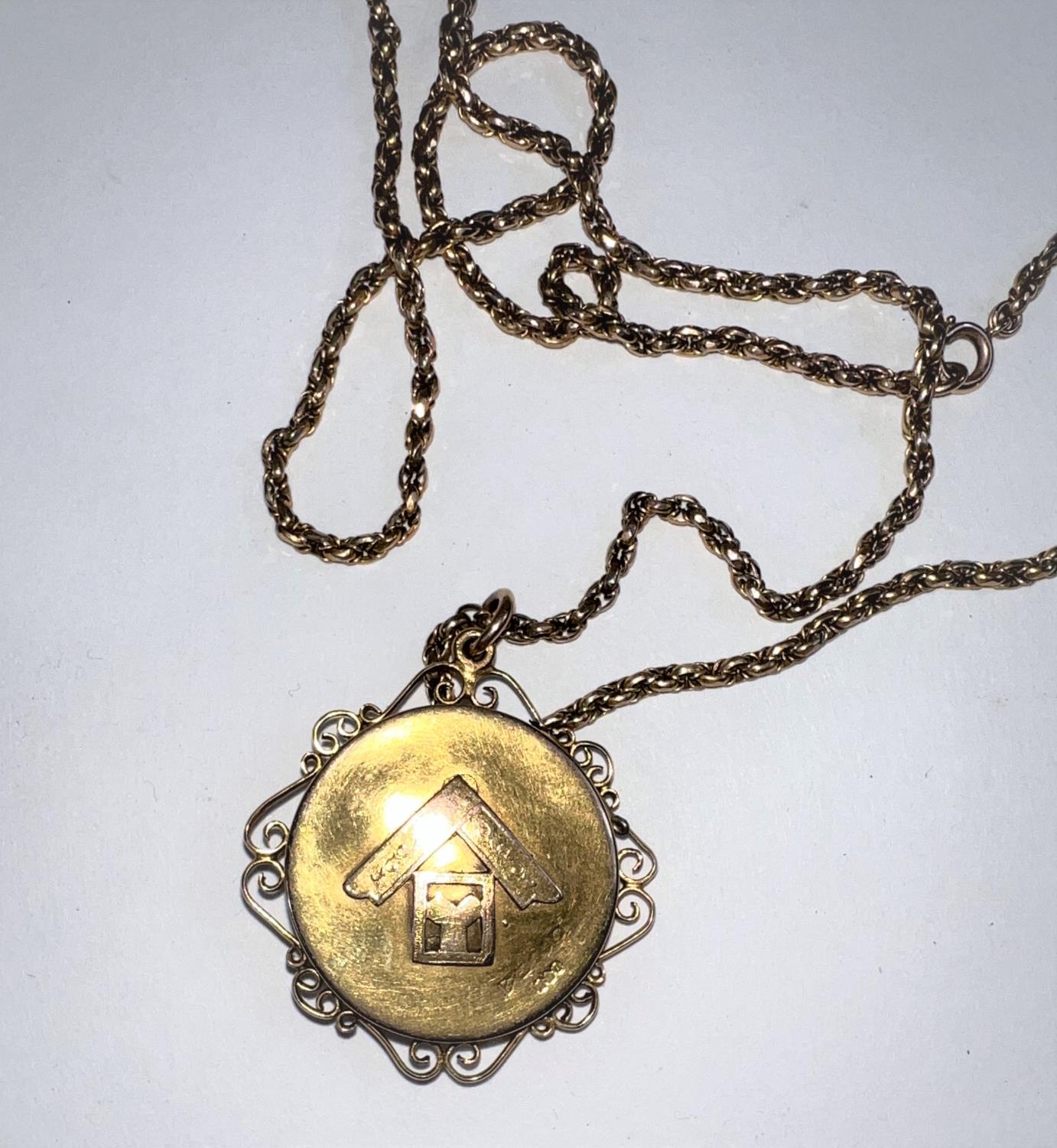 A Victorian 15 carat hallmarked gold pendant/ locket set with a ruby within a star, having scroll